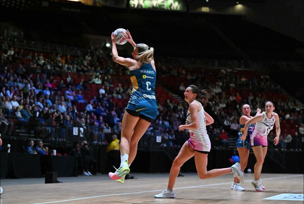 Netball player leaping to catch ball